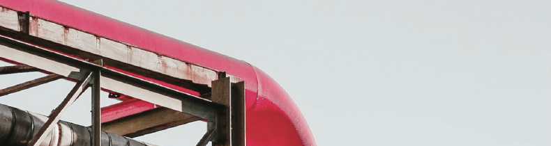 The magenta pipeline of the seminar poster, crossing a steel structure
